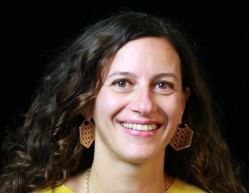 A close up head shot of Silene Bonato, Senior Programme Lead, AWS. She is smiling and looking into the camera.