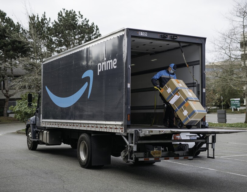 An Amazon driver delivers boxes of medical supplies.