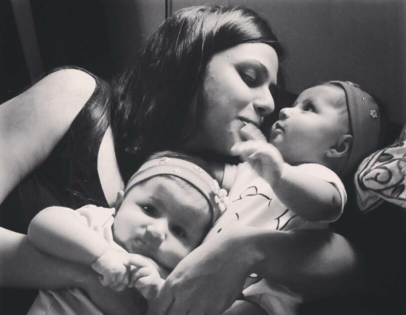 In the picture, Maliha is cuddling her two babies