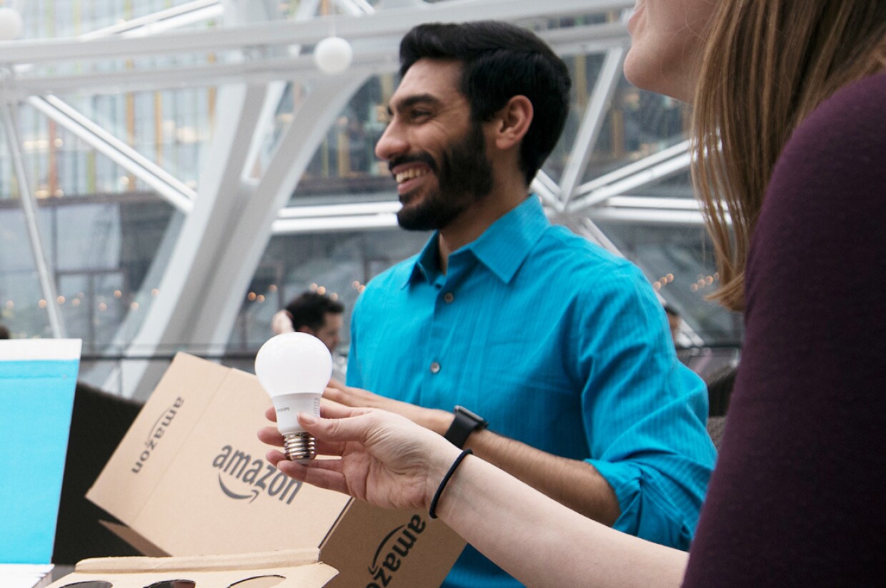 Three Amazon employees discuss Frustration-Free Packaging during a meeting in the Amazon's Seattle Spheres.
