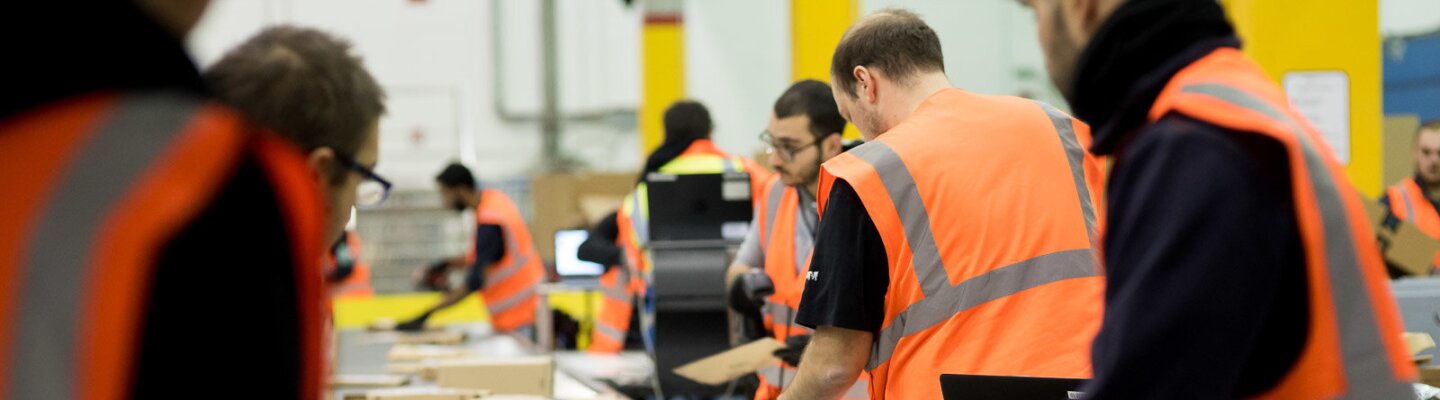 Amazon Fulfillment Center employees working