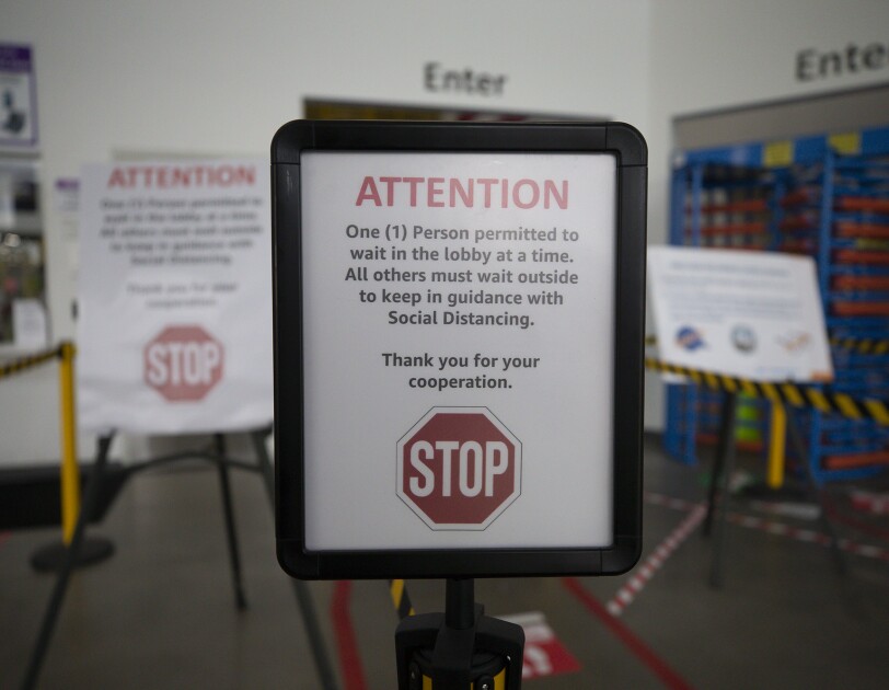 A sign at an Amazon fulfillment center noting social distance requirement