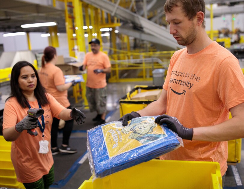 Amazon associates prepare tarps and other products for those impacted by Hurricane Dorian.