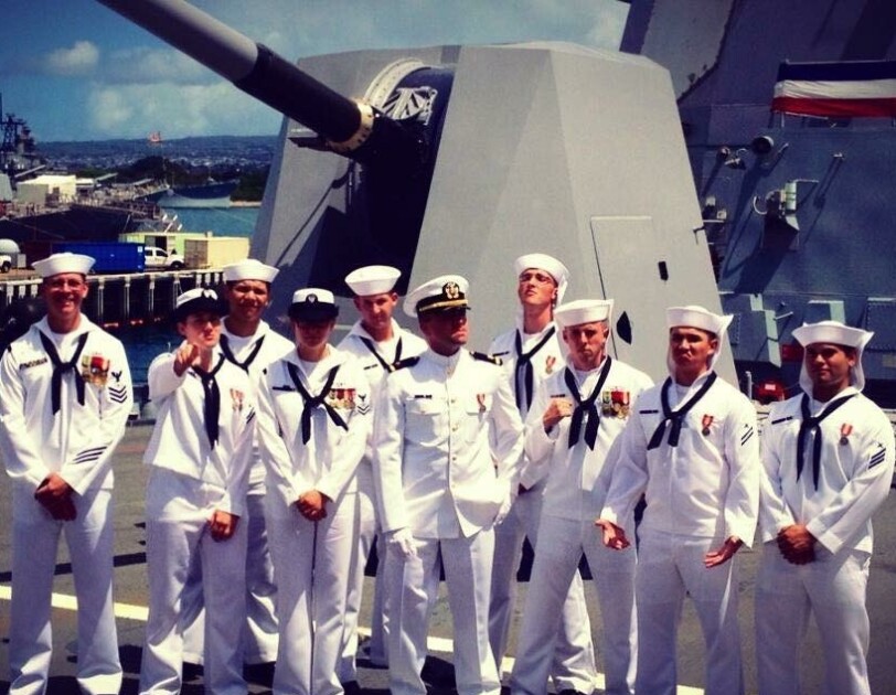 10 members of the U.S. Navy, pose together.