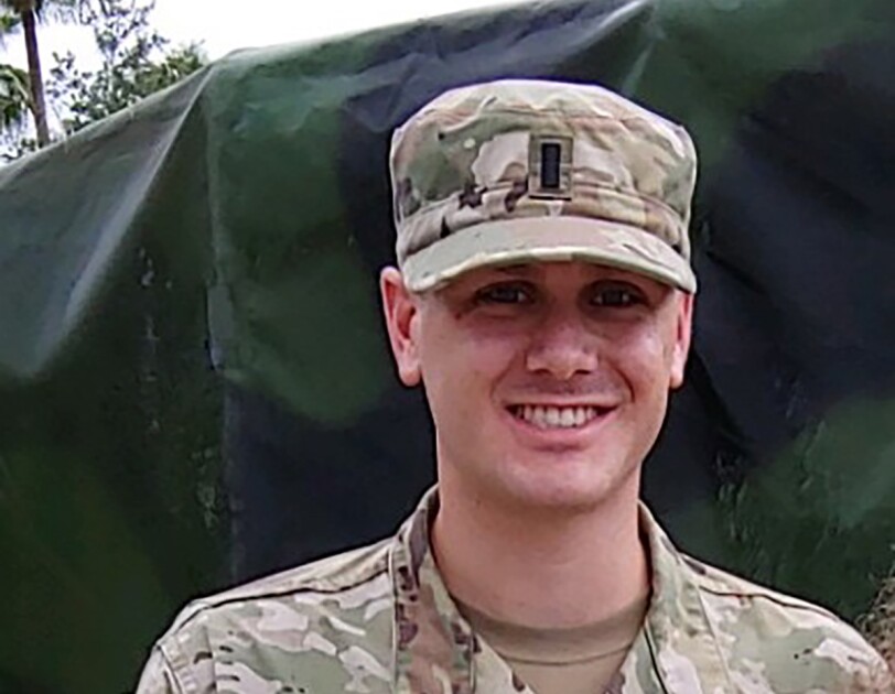 A man wearing a National Guard uniform in a military setting