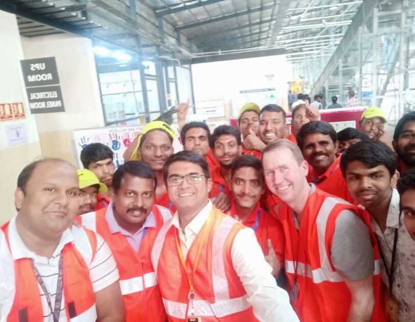 Deaf Associates in red vests take a selfie with John Felton on his visit to India