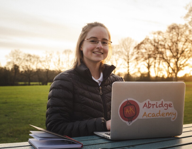Katie Prescott, founder of Abridge Academy, working on her laptop