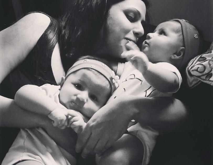 In the picture, Maliha is cuddling her two babies