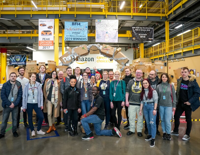 A group of Amazon employees on the 'I found the right place' programme standing in the Fulfilment Centre in Kent, Washington on a fulfilment centre tour.