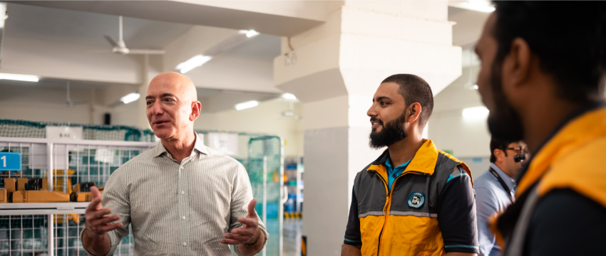 Jeff Bezos talks to employees at a fulfillment center