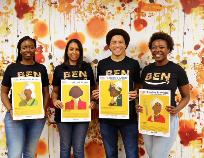 Orange and white group shot of employees holding artwork for BEN