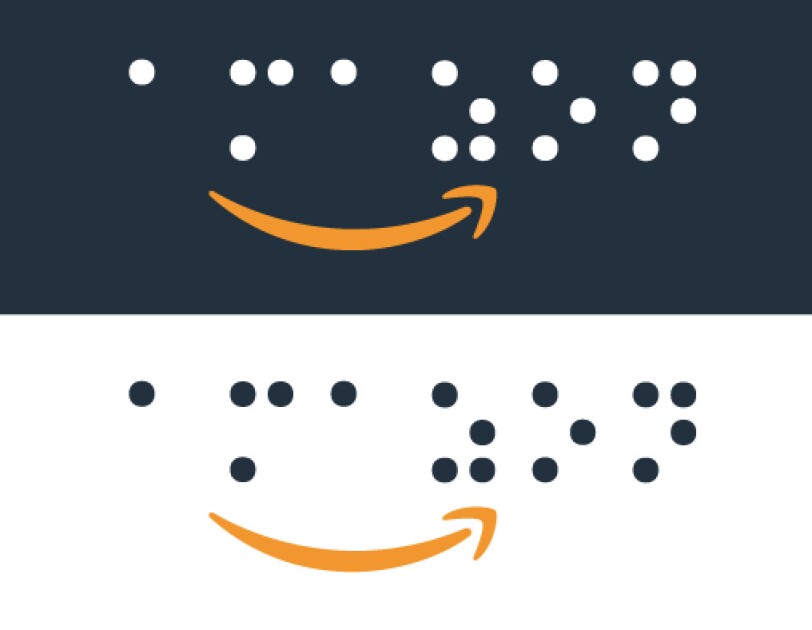 Amazon's logo in braille. The background is both black and white, and the Amazon Smile logo is in orange.