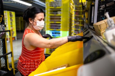 Amazon associate wears a mask while working. Photo taken during COVID-19 pandemic.