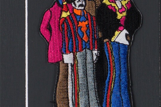 A sewn patch depicting the four members of the Beatles.