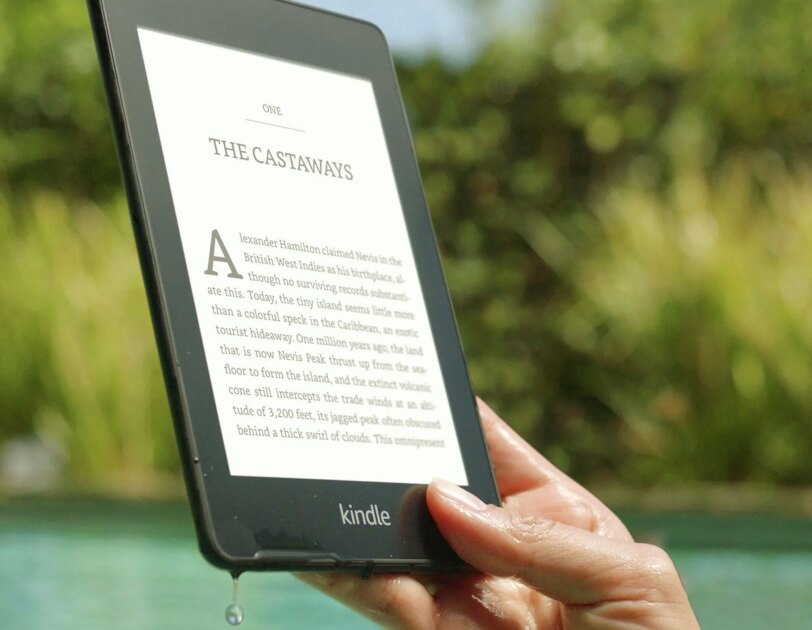 Waterproof Kindle Paperwhite being lifted out of a pool