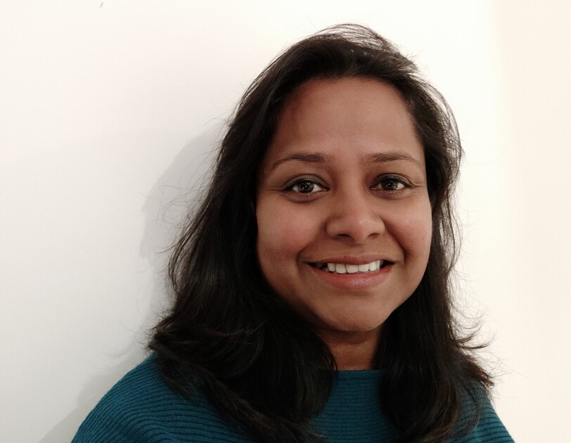 Headshot of Ramani Thangarasah-Halliwell, Customer Engagement Manager, AWS, she is smiling and looking at the camera.