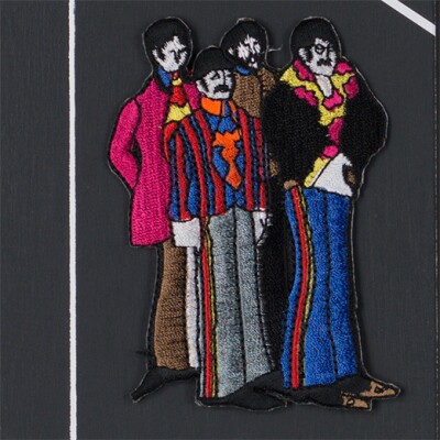 A sewn patch depicting the four members of the Beatles.