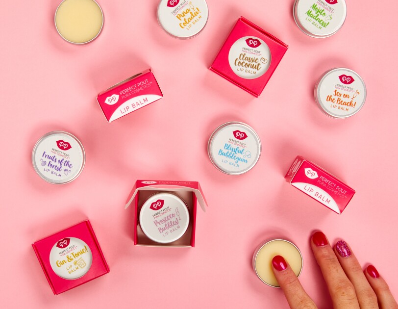 An image of the Pura Cosmetics large lips products in a pink table with someone using one of the products.