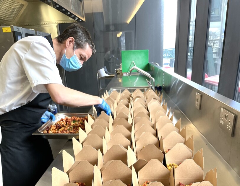 Alex Borley from BaxterStorey packing food boxes to donate to the local Shoreditch community.