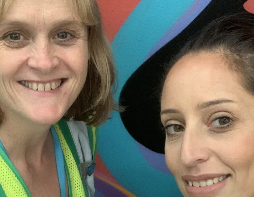 Two MEL1 women employees smile at the camera.
