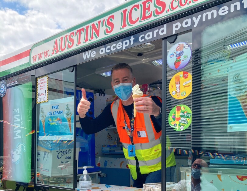 Mark Chew inside ice cream van at MAN3 holding an ice cream