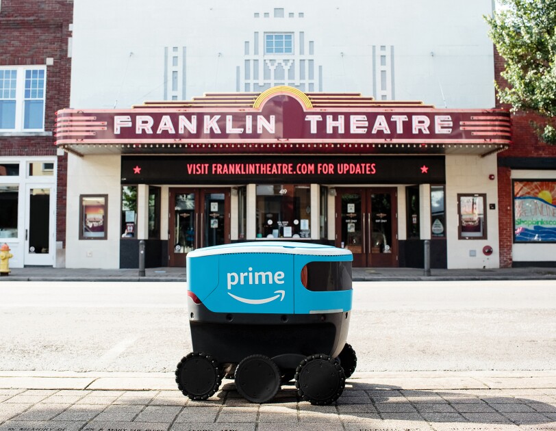 Amazon Scout bot posed in front of iconic landmarks