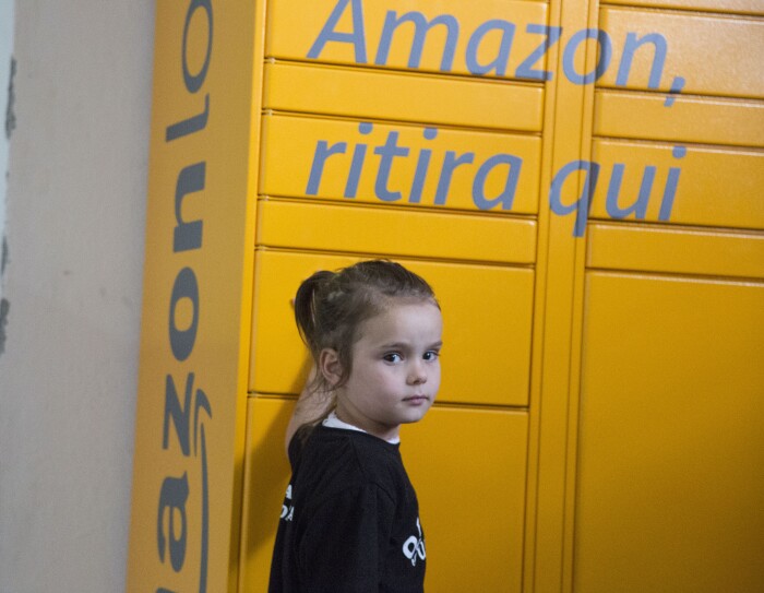 Una bambina davanti all'Amazon Locker Geremia nella Biblioteca di Scampia
