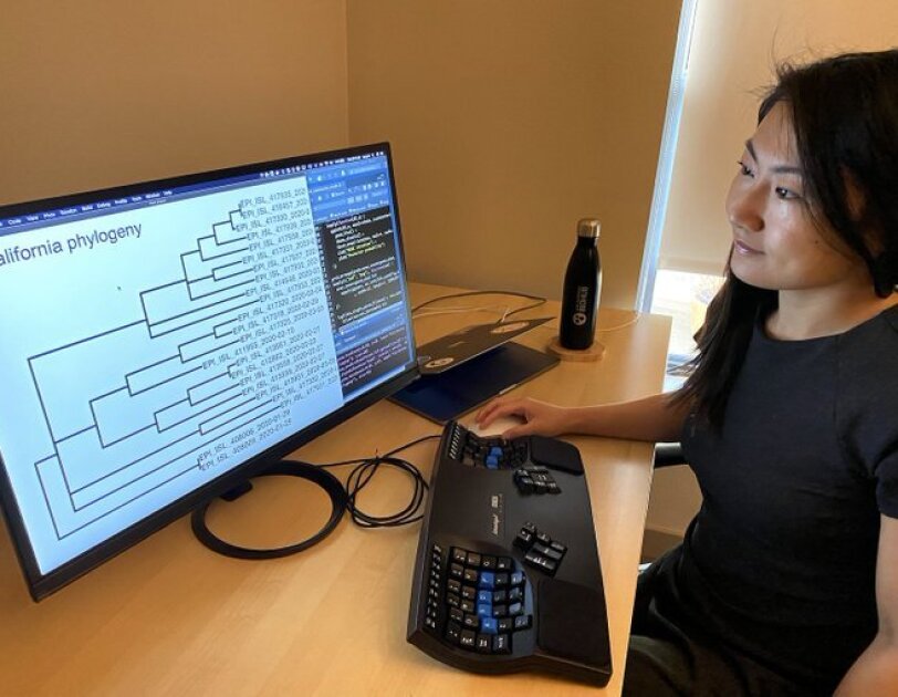 A woman works remotely from her home office.