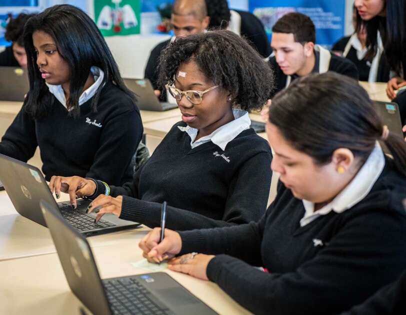 Students at Monsignor Scanlan High School working on laptop computers as they learn about computer science.