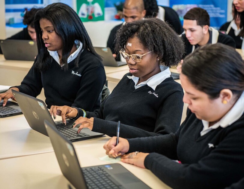 Students at Monsignor Scanlan High School working on laptop computers as they learn about computer science.