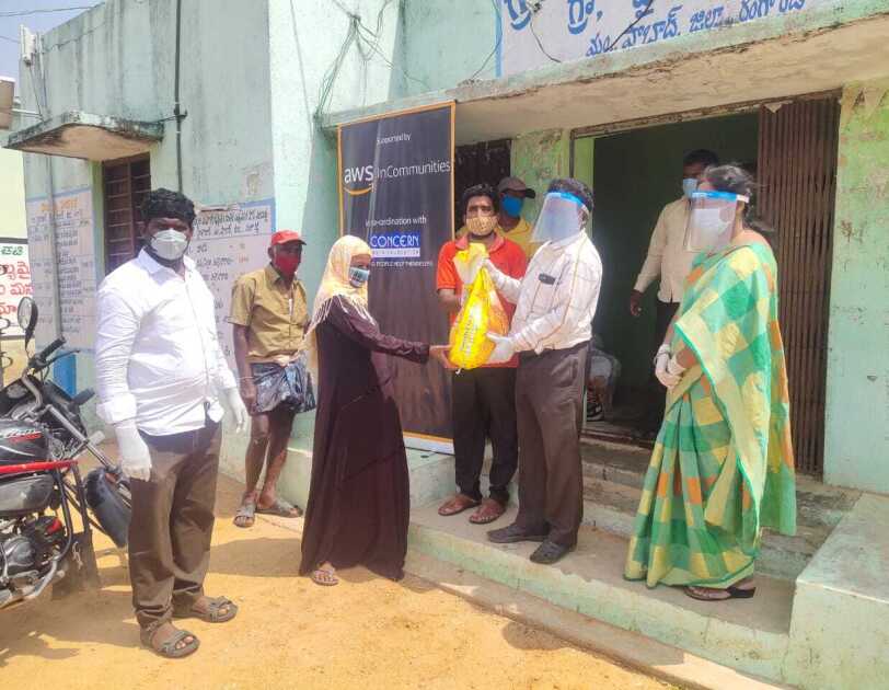 AWS in communities Telangana - a woman receiving dry ration