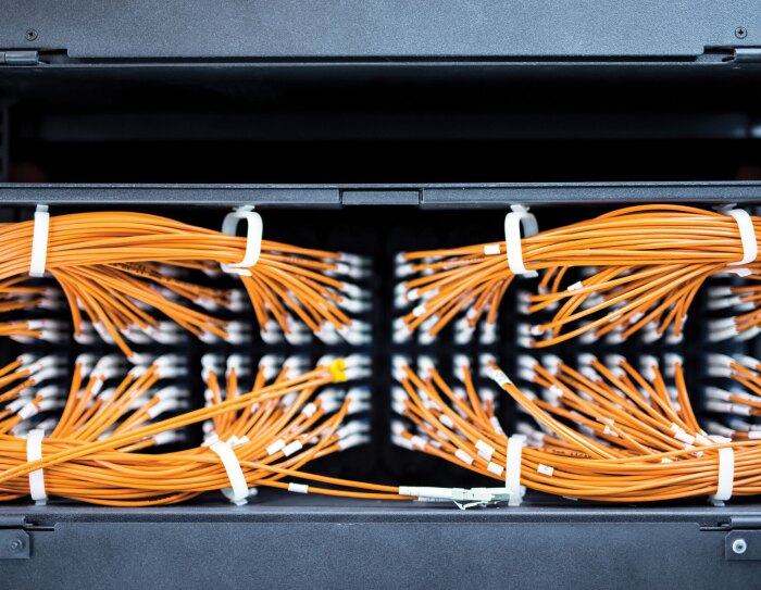 A collection of secured, orange AWS server cables.