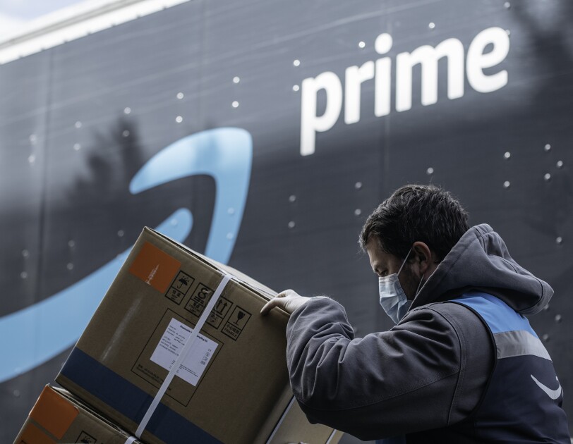 An Amazon driver delivers boxes of medical supplies.