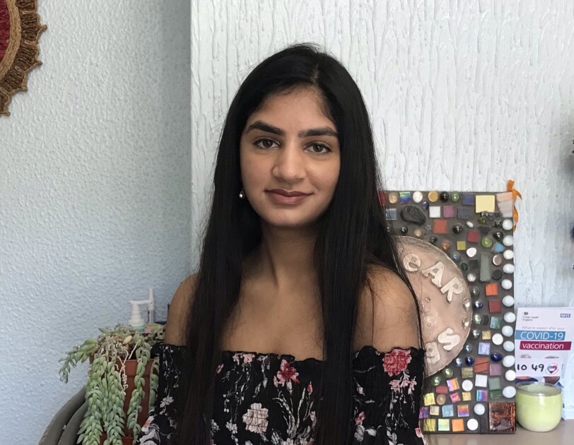 Riddhi Patel standing in front of her fireplace