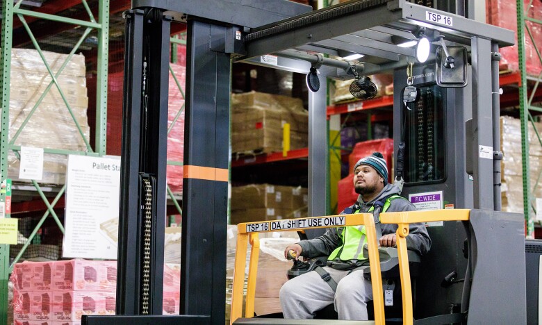 An Amazon employee drives a forklift at BFI3 in DuPont, WA