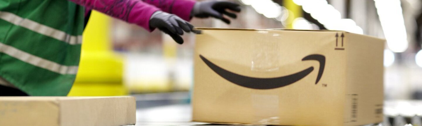 Fulfillment center employee handling a large package