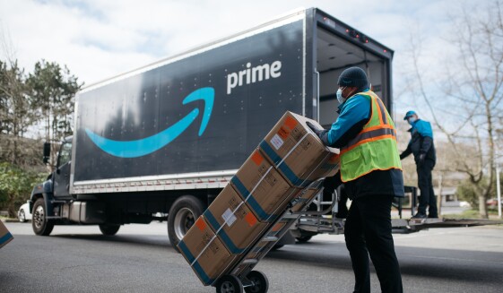 An Amazon driver delivers boxes of medical supplies.