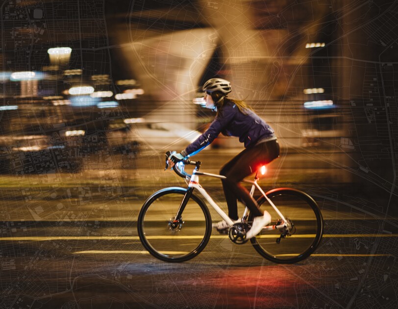 female cyclist pictured on a city map background