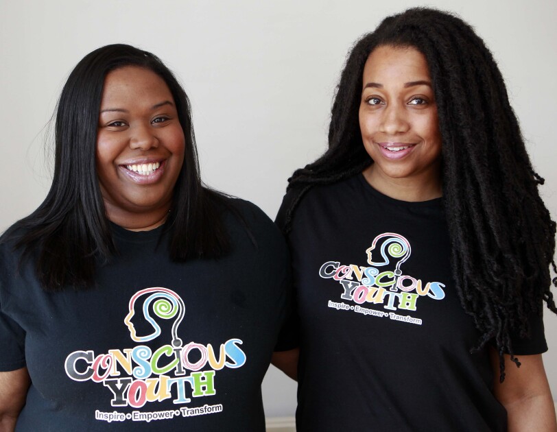 An image of Sophie and Serena from Conscious Youth, they are wearing t shirts with their logo on it.