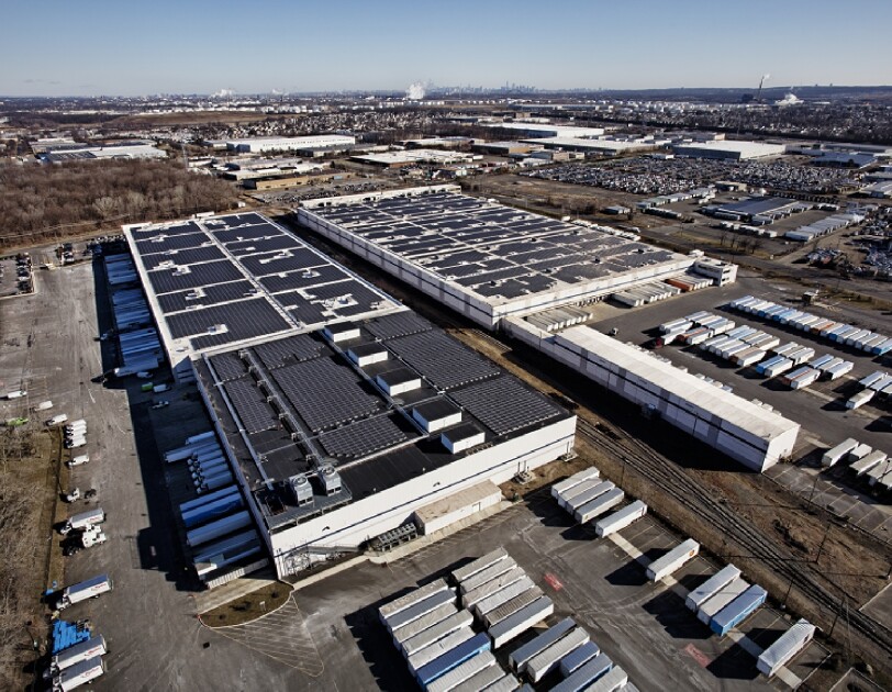Solar panels on top of a large building.