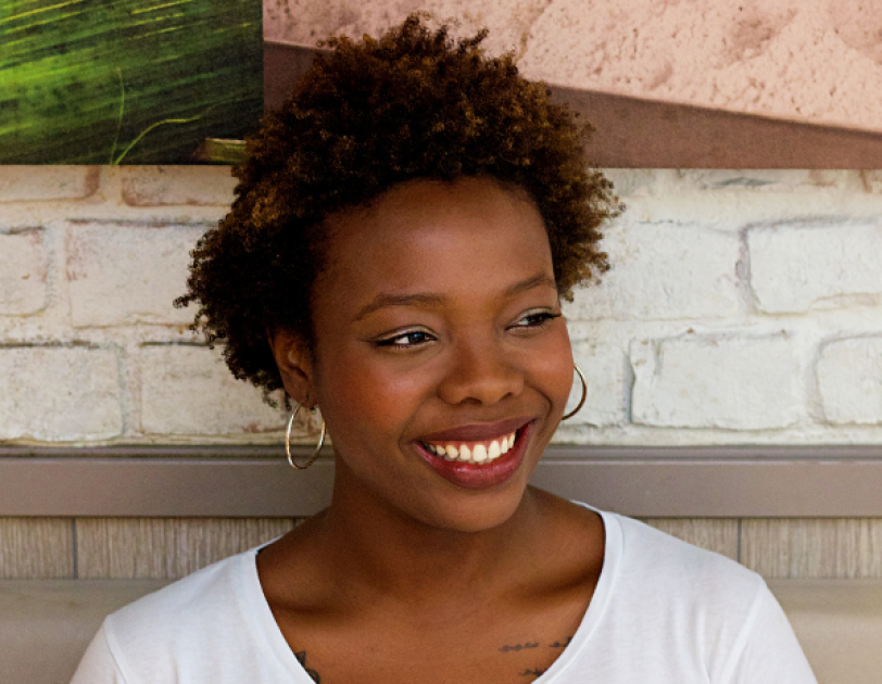 Headshot of Aisha Suleiman next to the EMpower and Yahoo Finance logos.