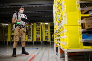 Amazon associate wears a mask while working. Photo taken during COVID-19 pandemic.
