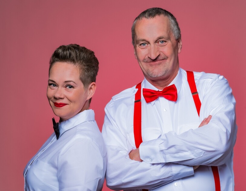 Ein Mann und eine Frau in weißen Hemden und mit Fliegen.