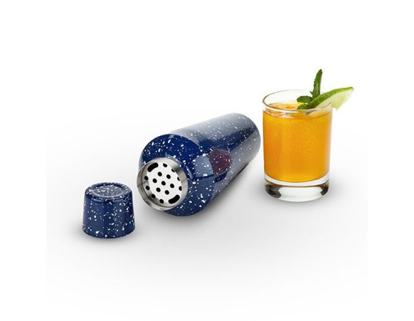 Speckled blue camp-style cocktail shaker lies on its side. To the right is a cocktail in a lowball glass with lime slice and mint leaf.