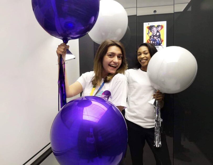 Amazon employees holding balloons for International women's day