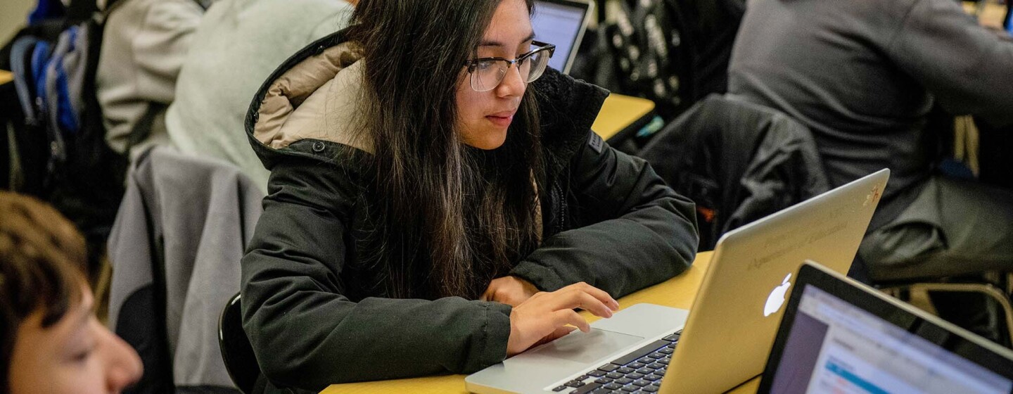 Students work on coding programs on laptop computers in a classroom at a New York City school.