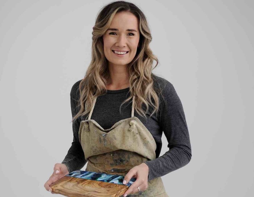 Kate Chesters holding one of her resin boards