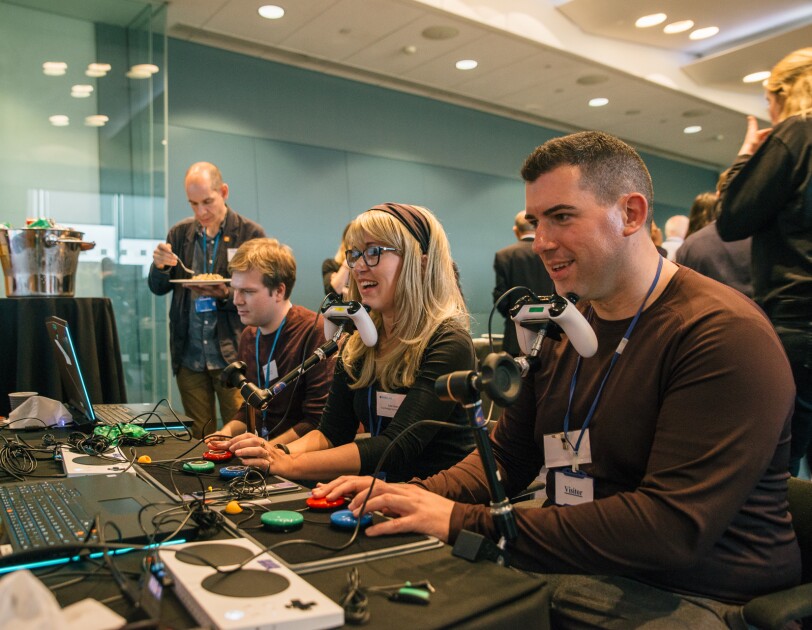 People playing on adapted games kit run by Special Effect at TechShare Pro 18.