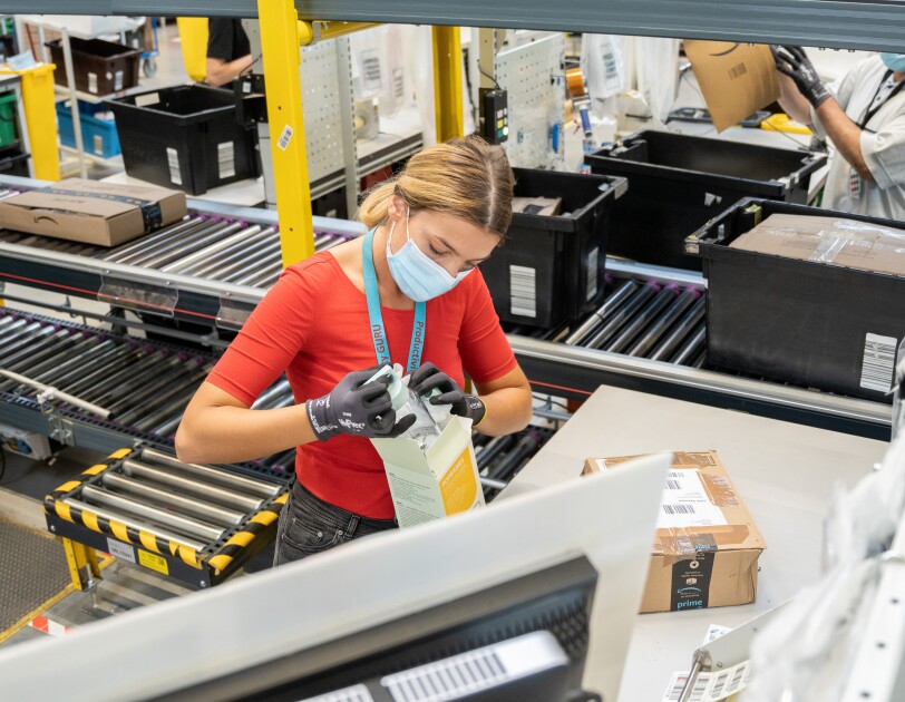 amazon employee inspects returned products at fulfilment centre