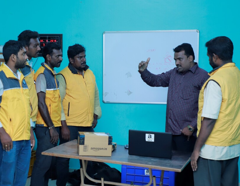 Service Partner speaking with his associates in his office